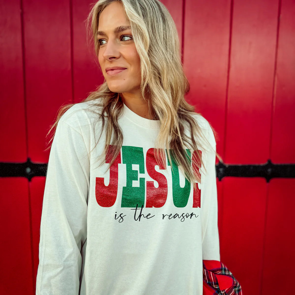 Woman wearing a Jesus is the reason long sleeve graphic tee.