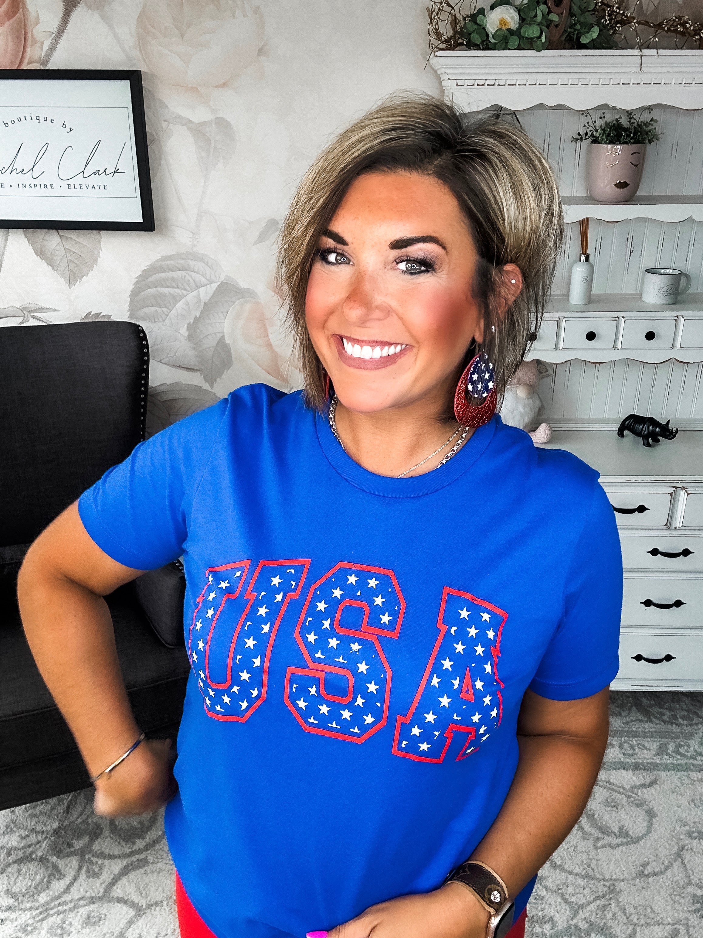 A person wearing a blue graphic tee with 'USA' and stars design.