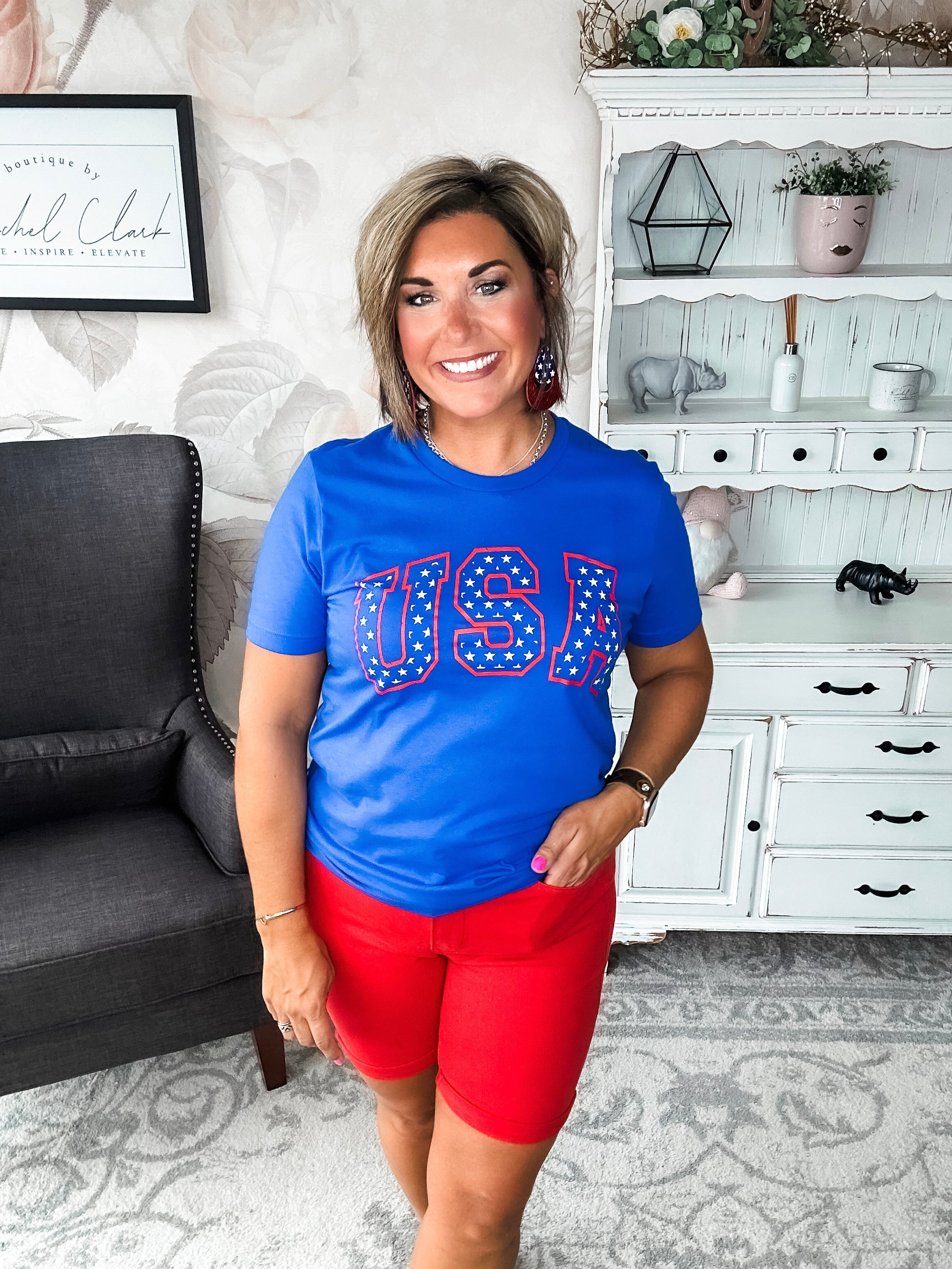 A person wearing a blue graphic tee with 'USA' and stars design.
