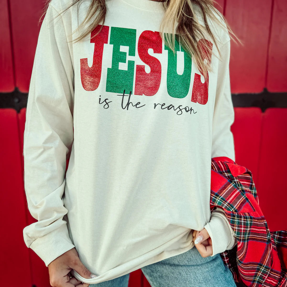 Woman wearing a Jesus is the reason long sleeve graphic tee.