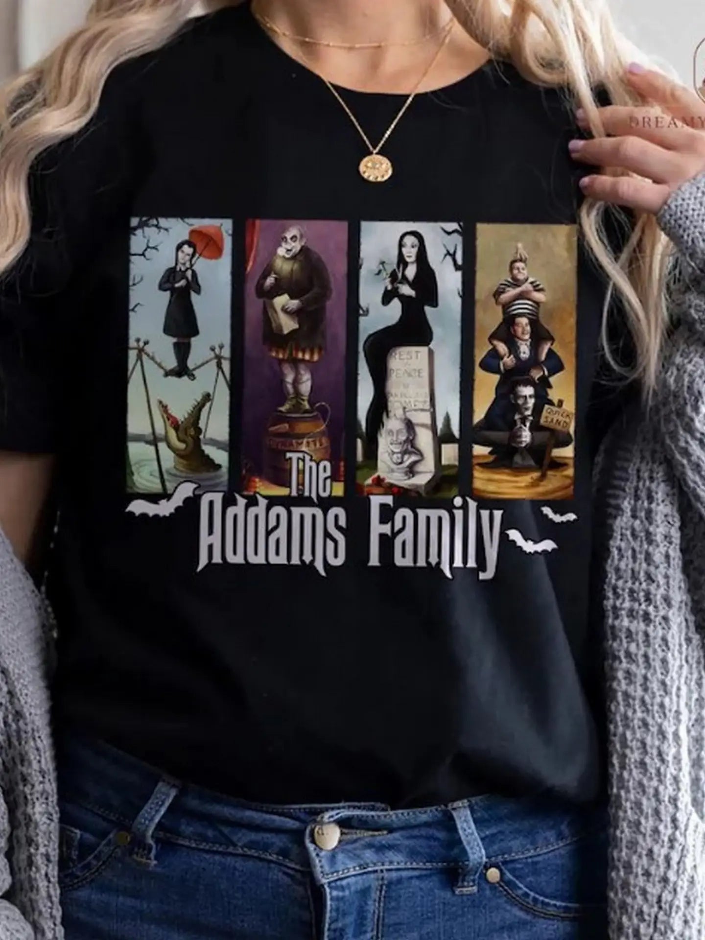 Woman wearing a black t-shirt with 'The Addams Family' graphic design.