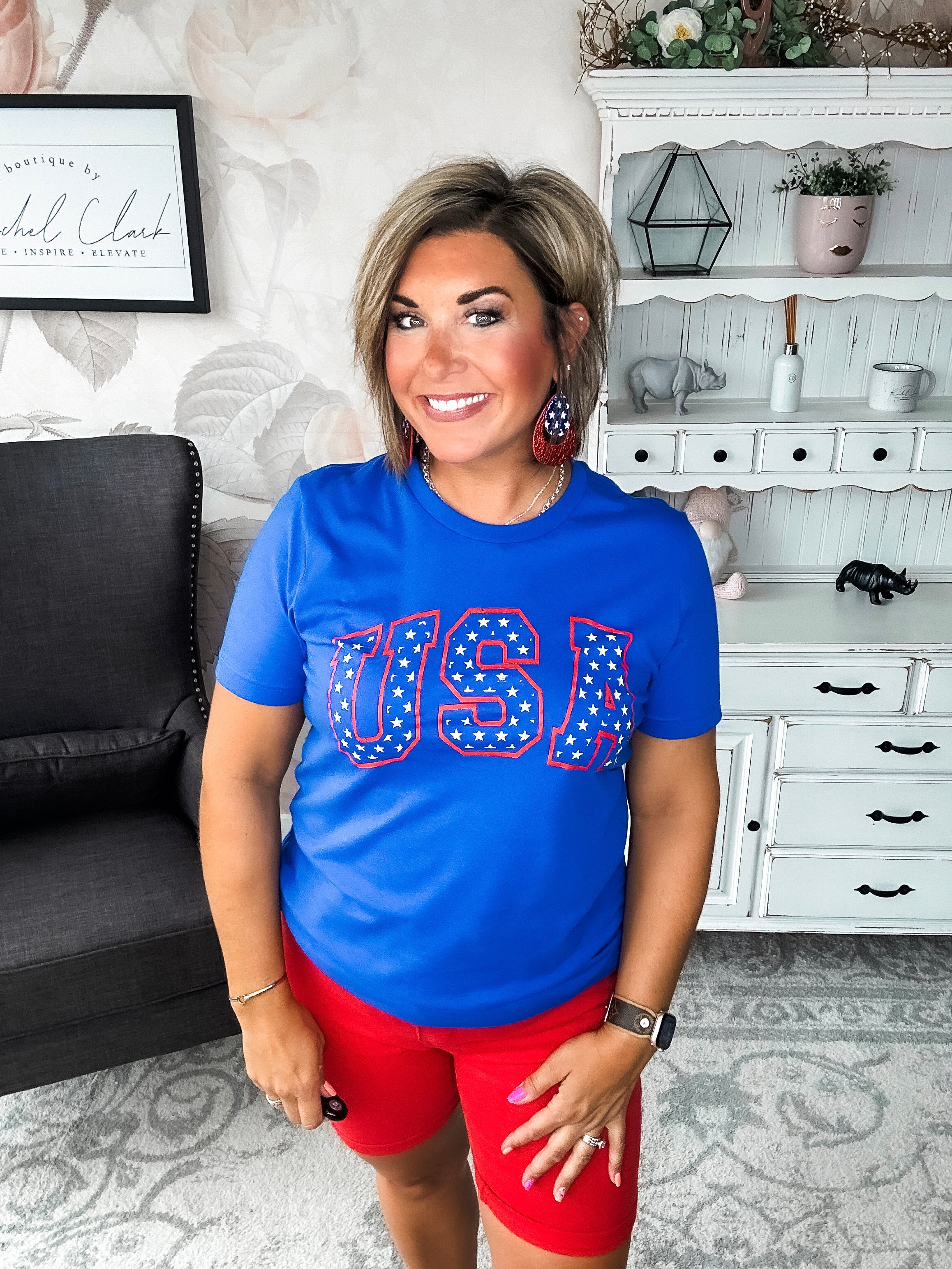 A person wearing a blue graphic tee with 'USA' and stars design.