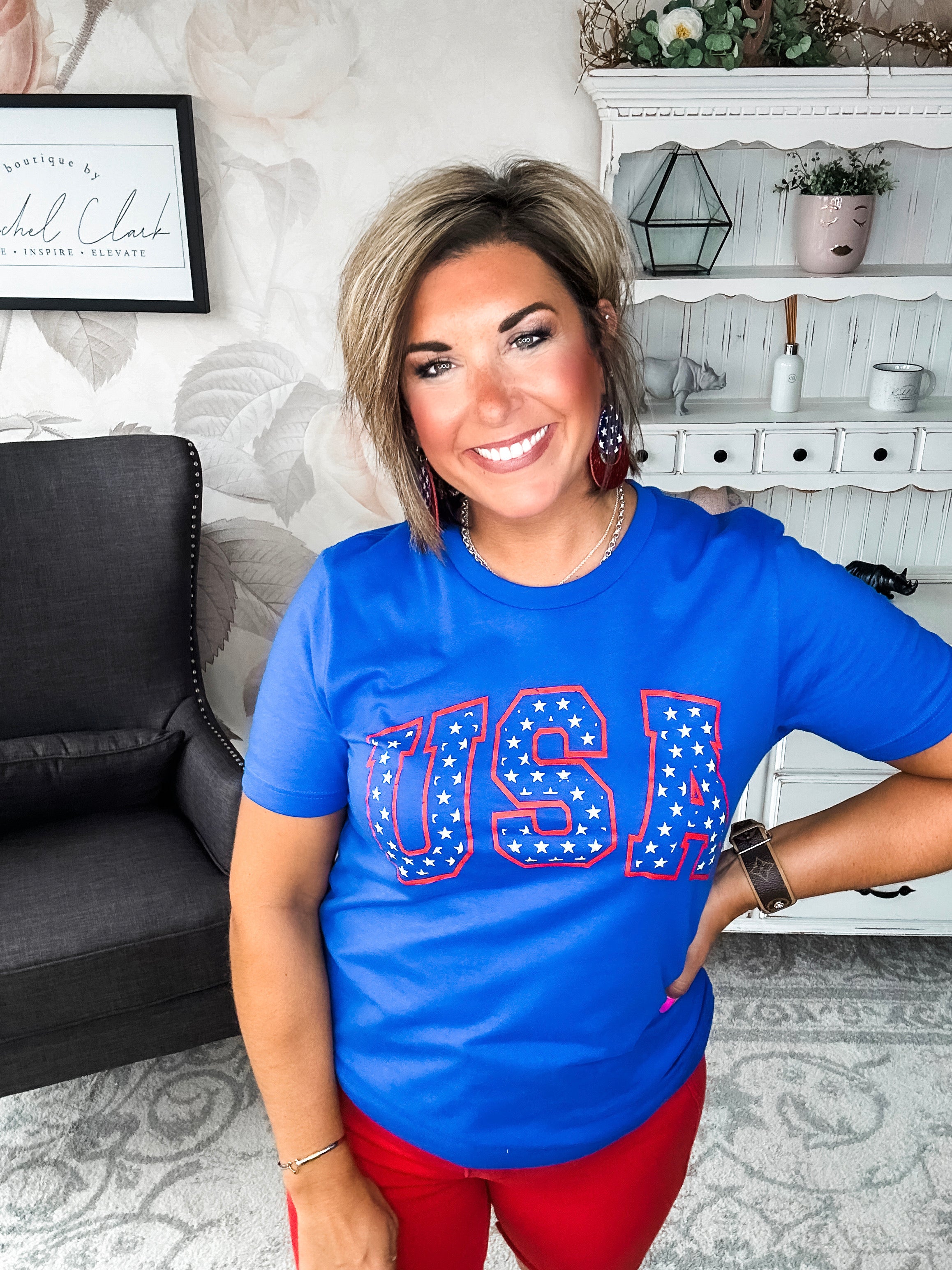 A person wearing a blue graphic tee with 'USA' and stars design.