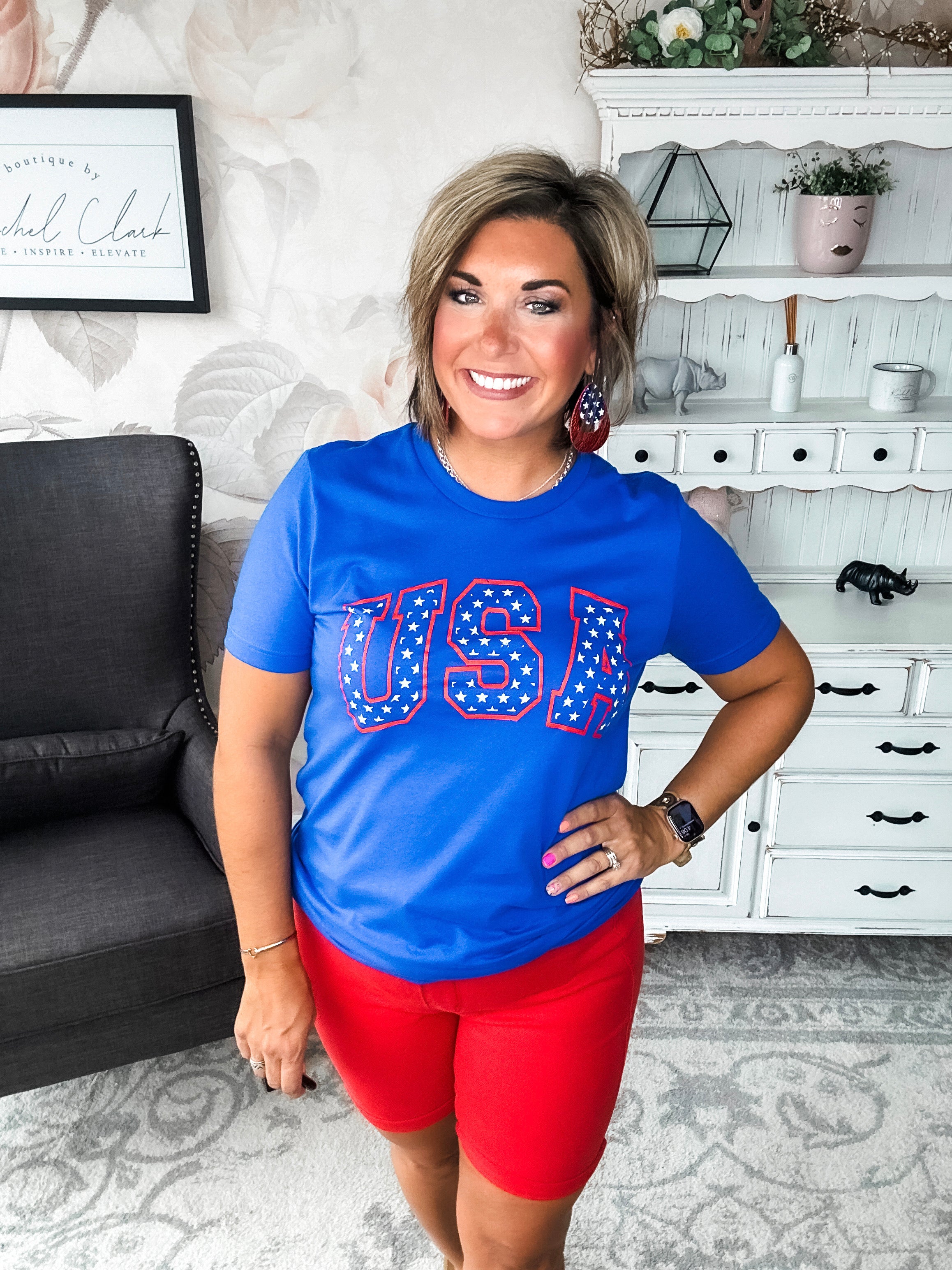 A person wearing a blue graphic tee with 'USA' and stars design.
