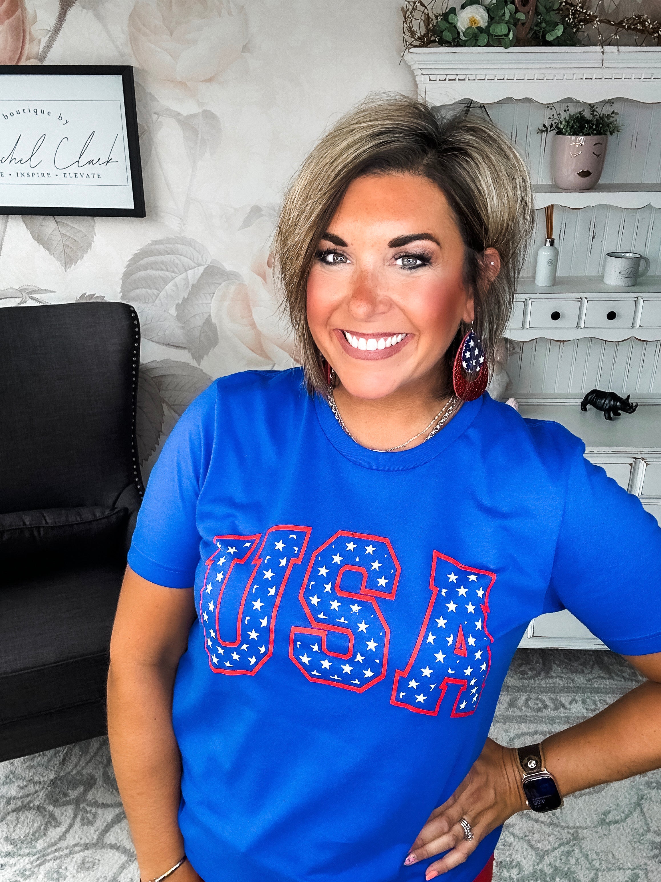 A person wearing a blue graphic tee with 'USA' and stars design.