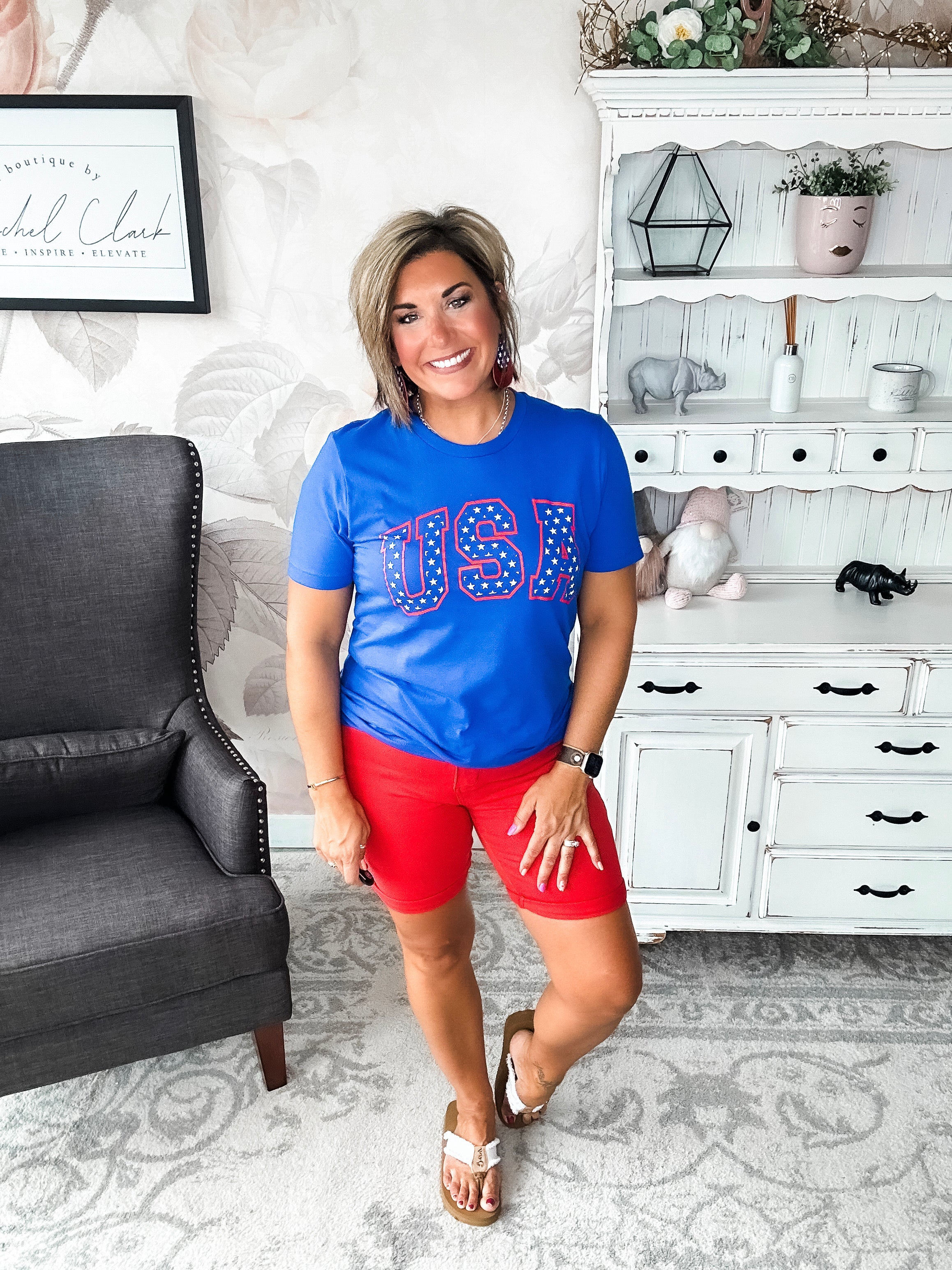 A person wearing a blue graphic tee with 'USA' and stars design.