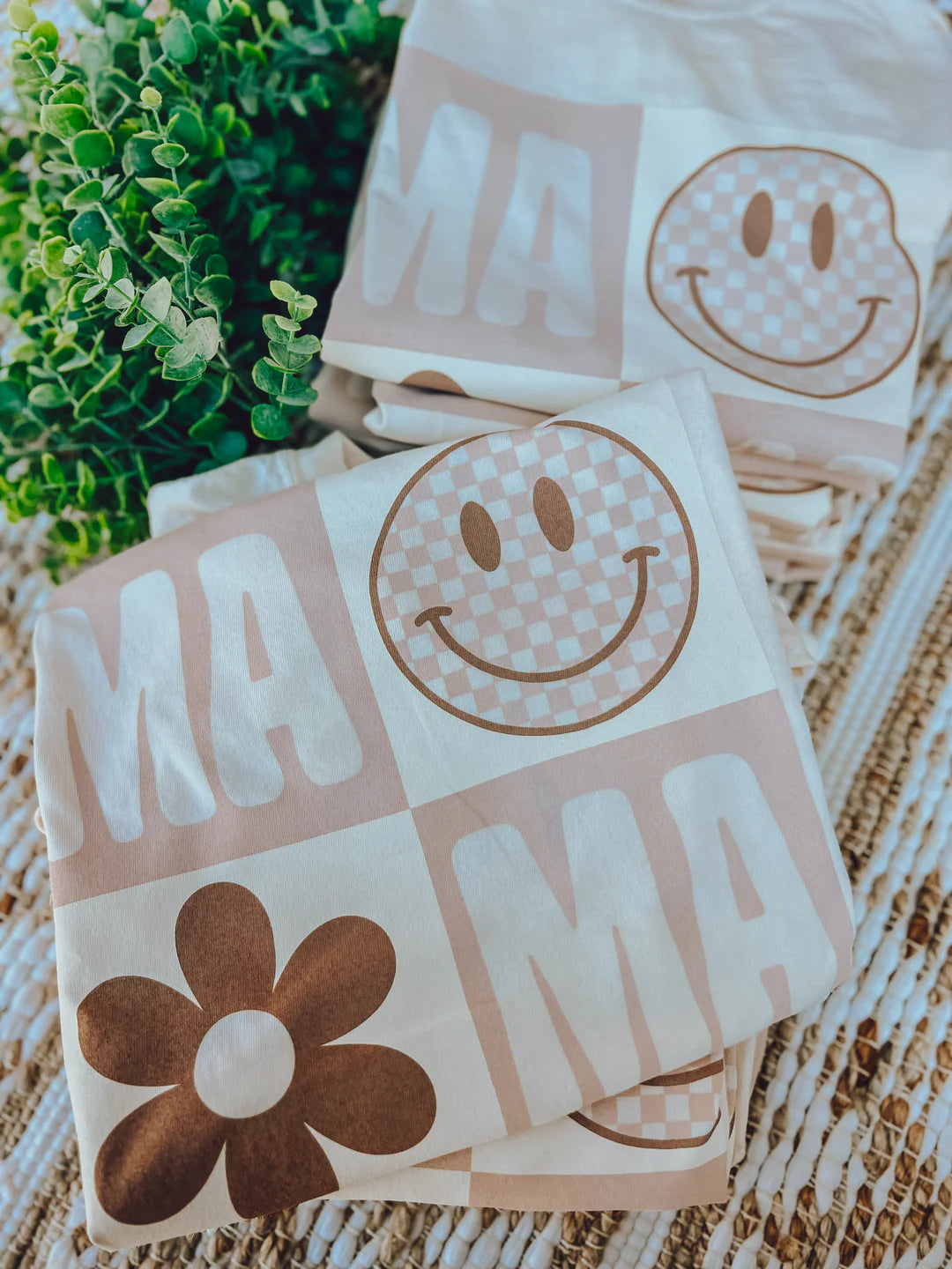 A cream crew-neck t-shirt with a smiley face graphic and text that reads 'MAMA'.