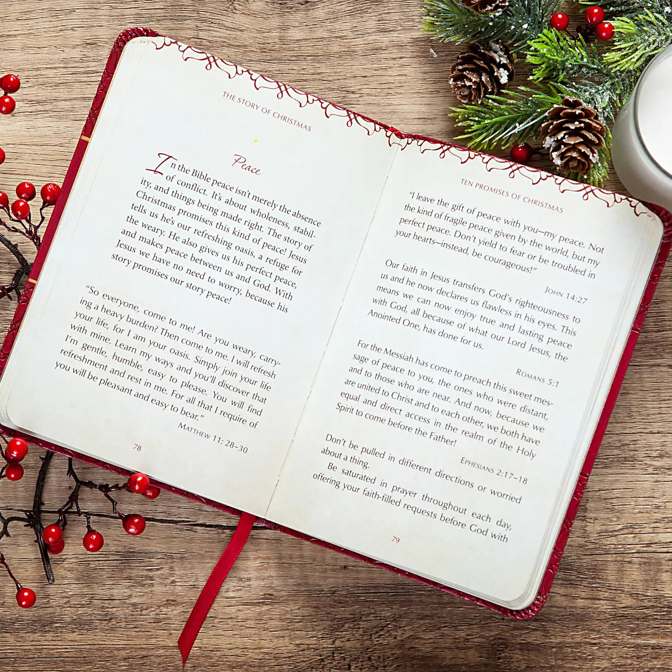 Open book with Christmas-themed pages on a wooden surface with festive decorations.