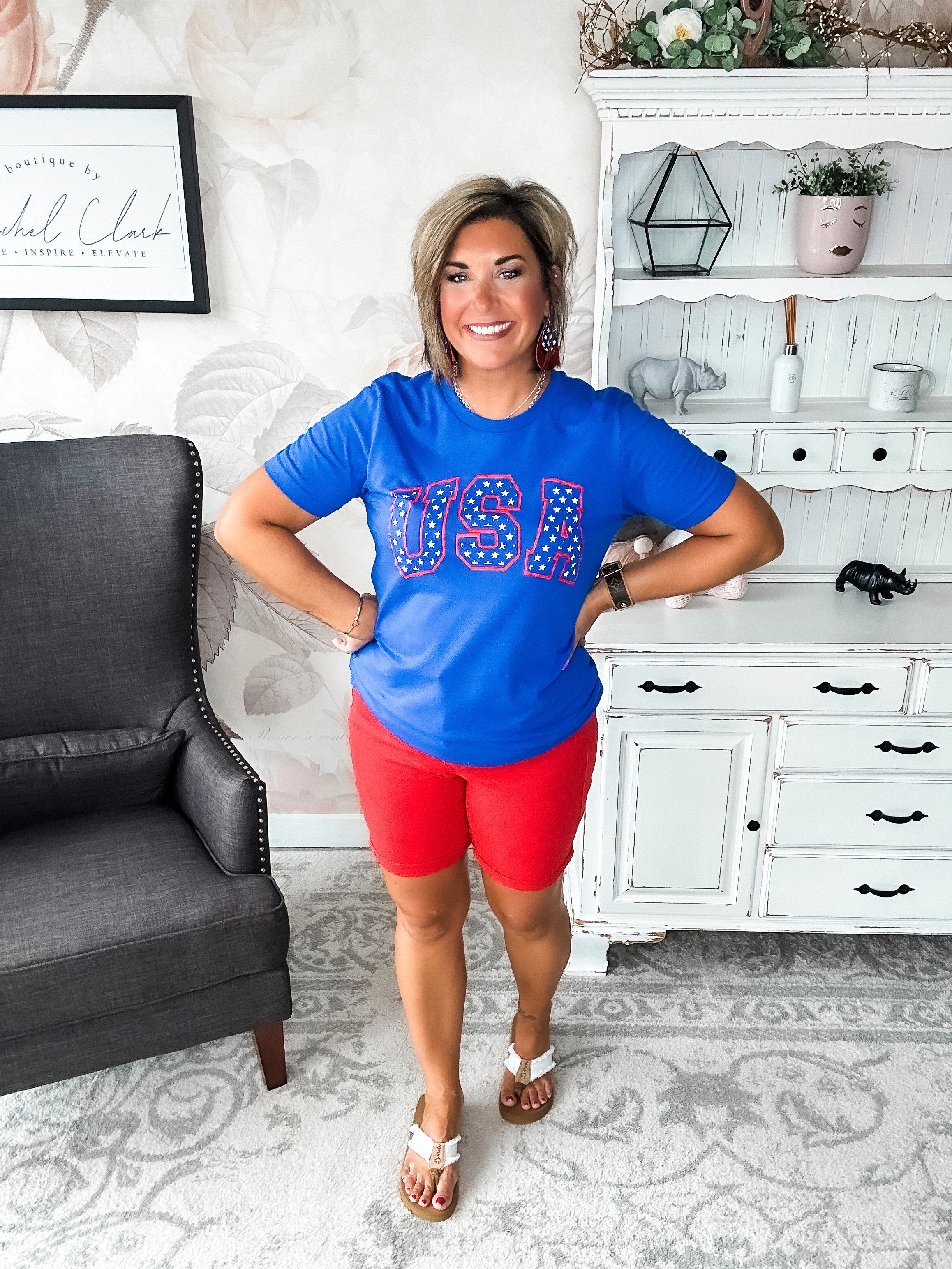 A person wearing a blue graphic tee with 'USA' and stars design.