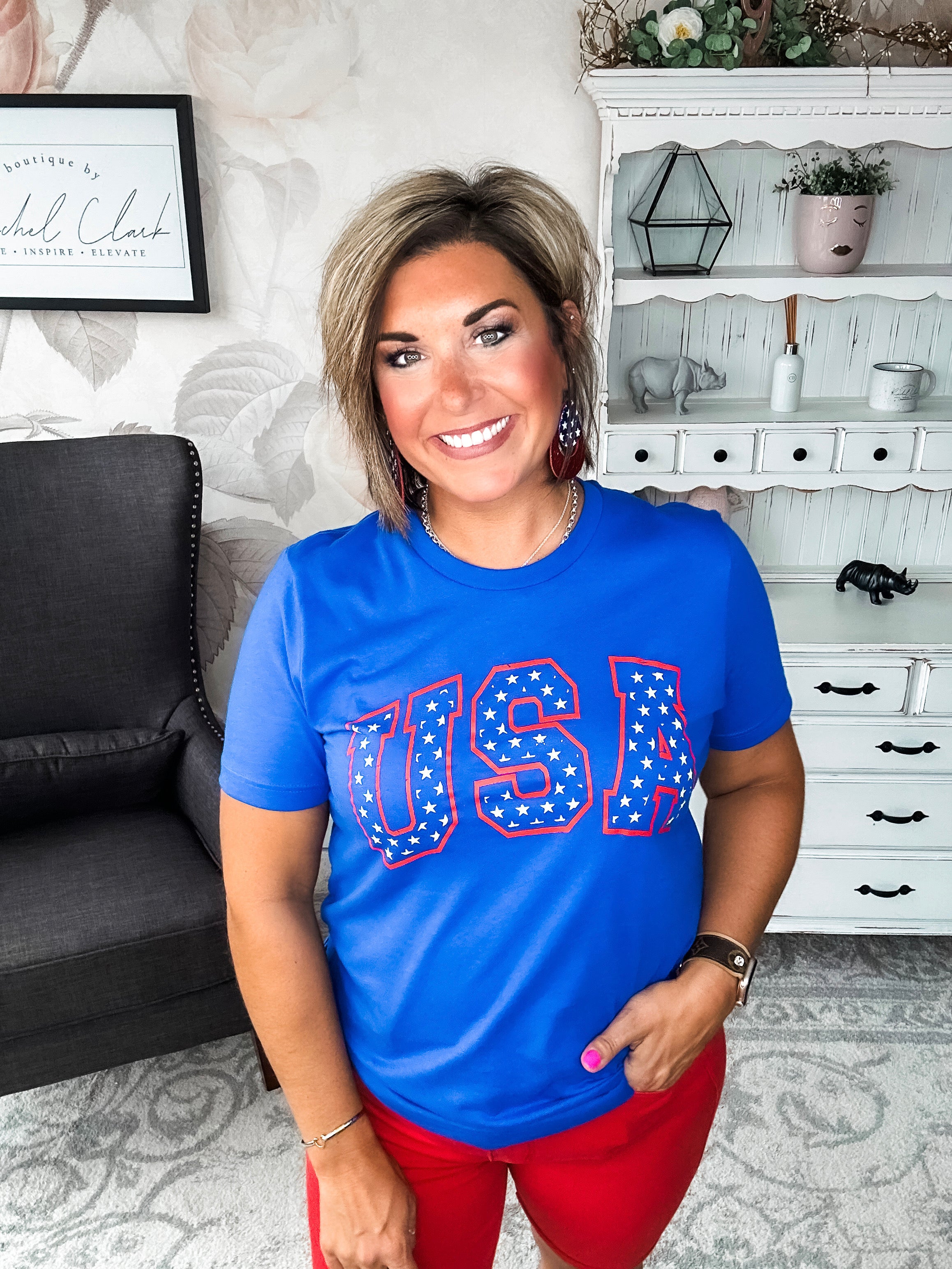 A person wearing a blue graphic tee with 'USA' and stars design.