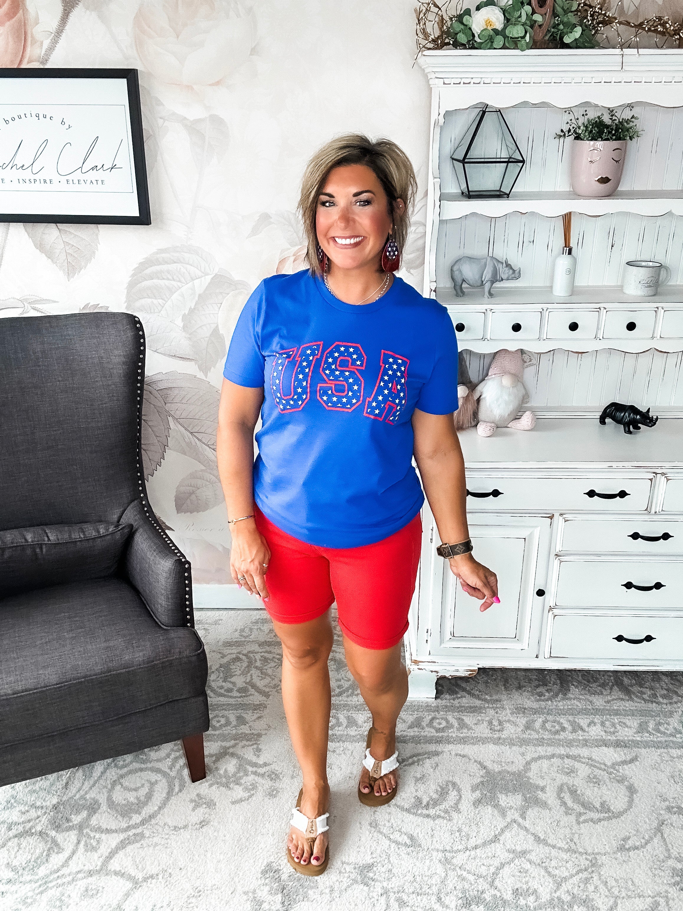 A person wearing a blue graphic tee with 'USA' and stars design.