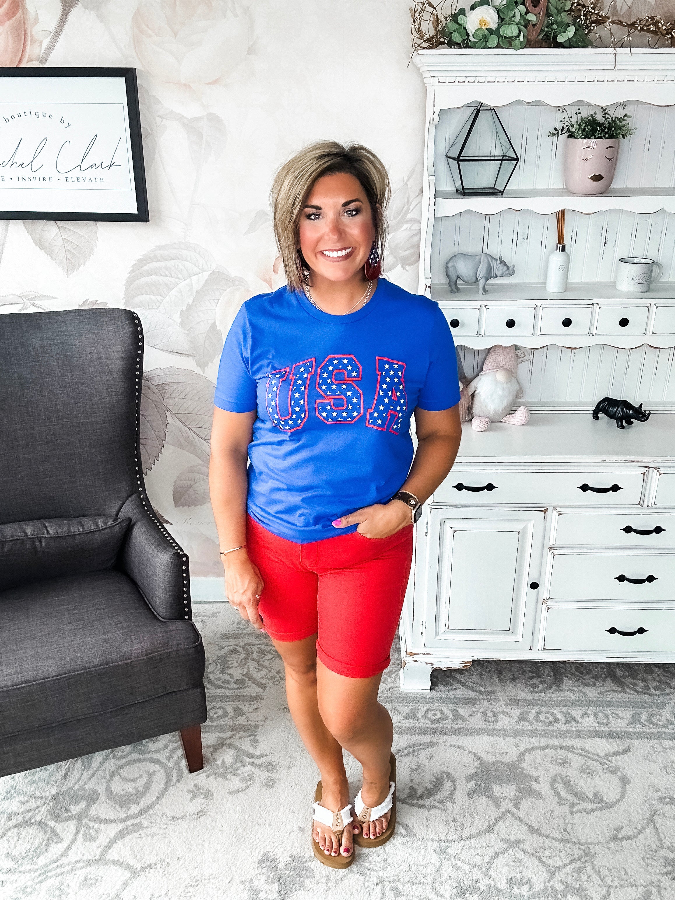 A person wearing a blue graphic tee with 'USA' and stars design.