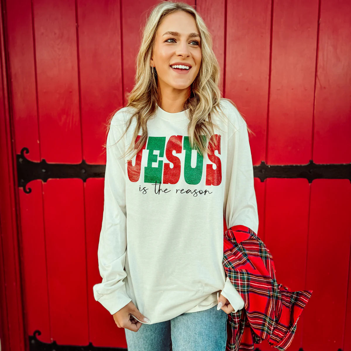 Woman wearing a Jesus is the reason long sleeve graphic tee.