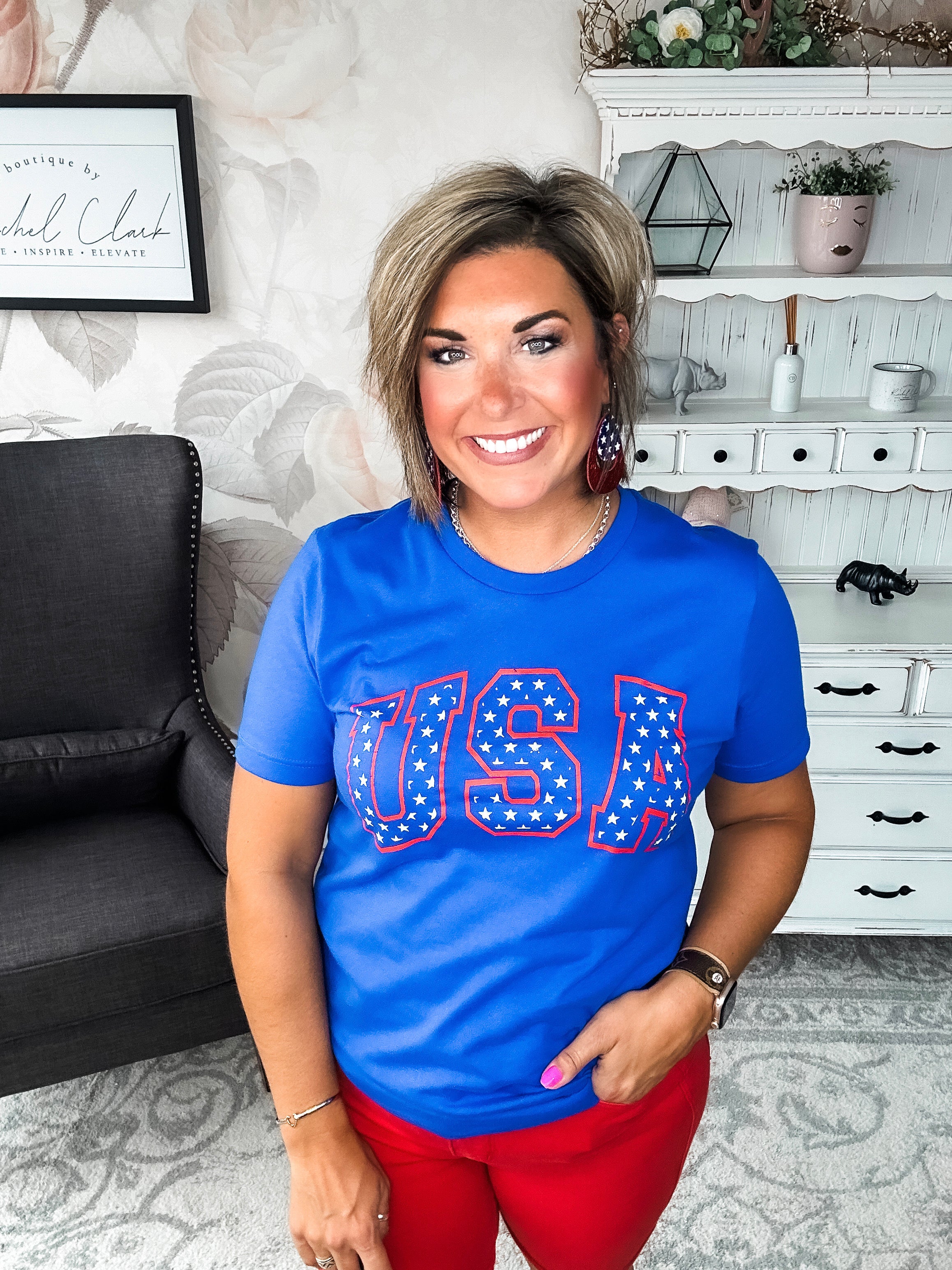 A person wearing a blue graphic tee with 'USA' and stars design.