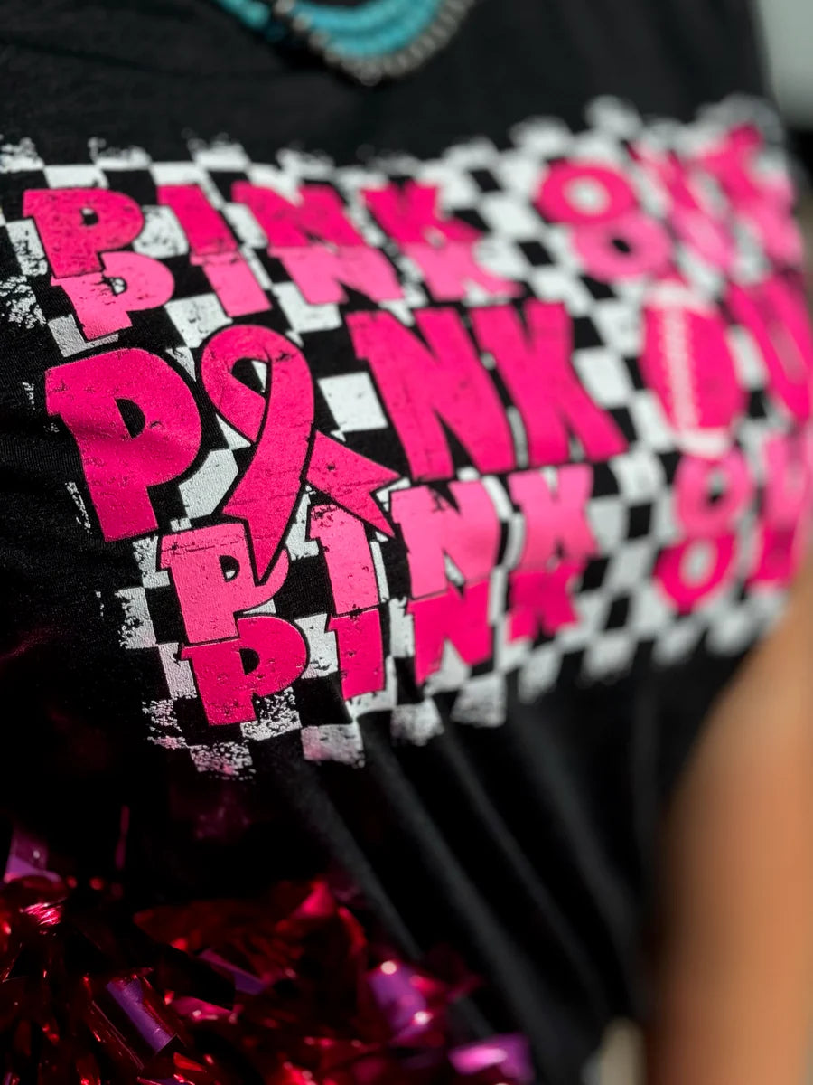 Woman wearing a black t-shirt with pink text that reads 'Pink Out' repeatedly with a football graphic.