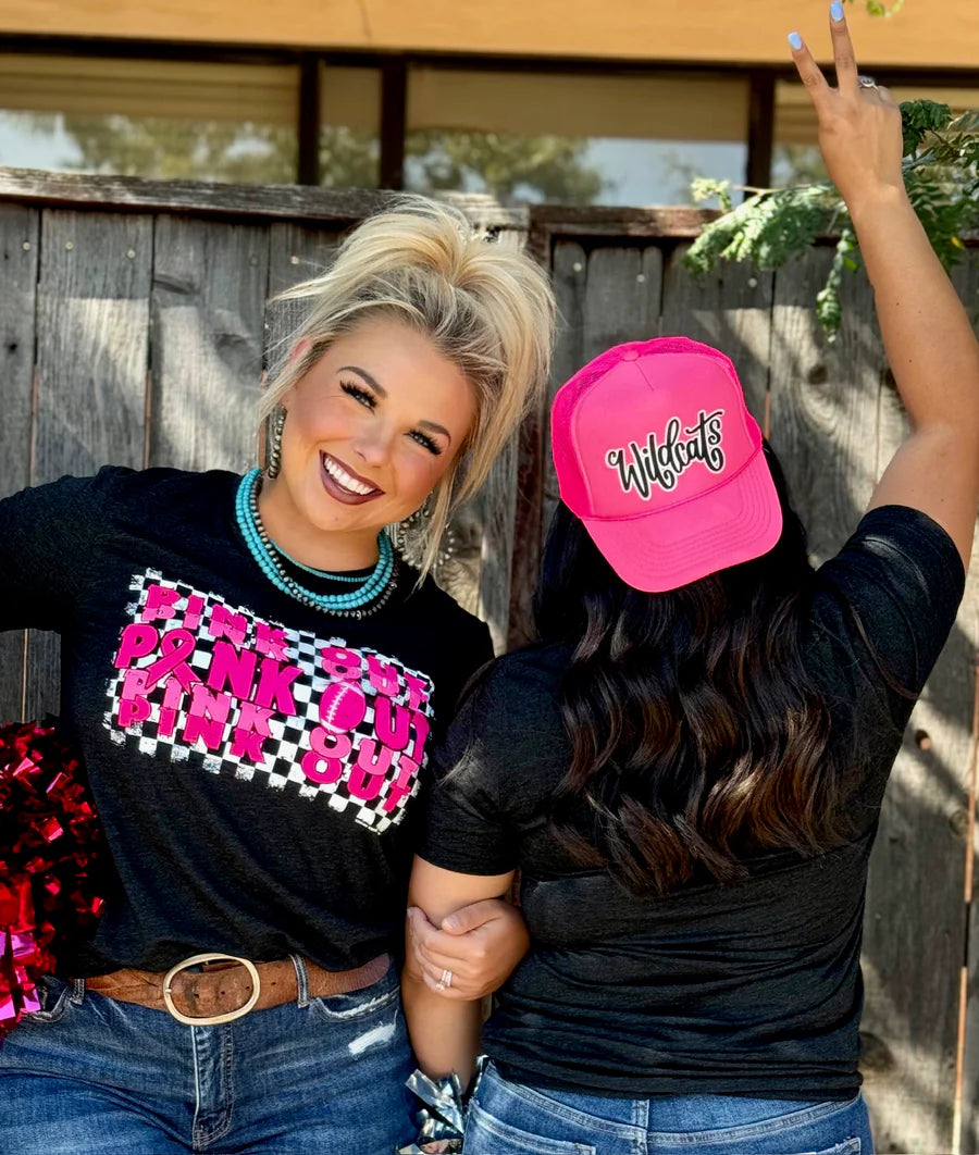 Woman wearing a black t-shirt with pink text that reads 'Pink Out' repeatedly with a football graphic.