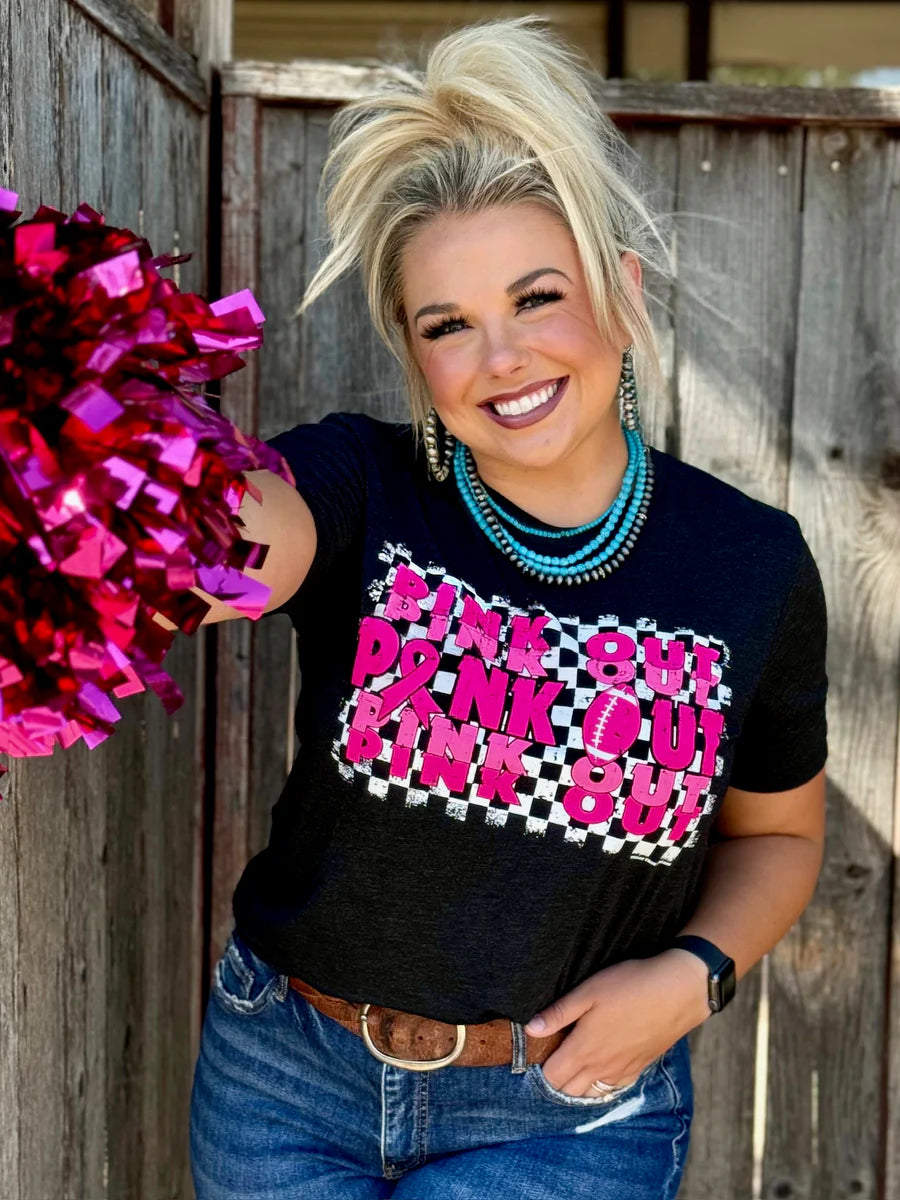 Woman wearing a black t-shirt with pink text that reads 'Pink Out' repeatedly with a football graphic.