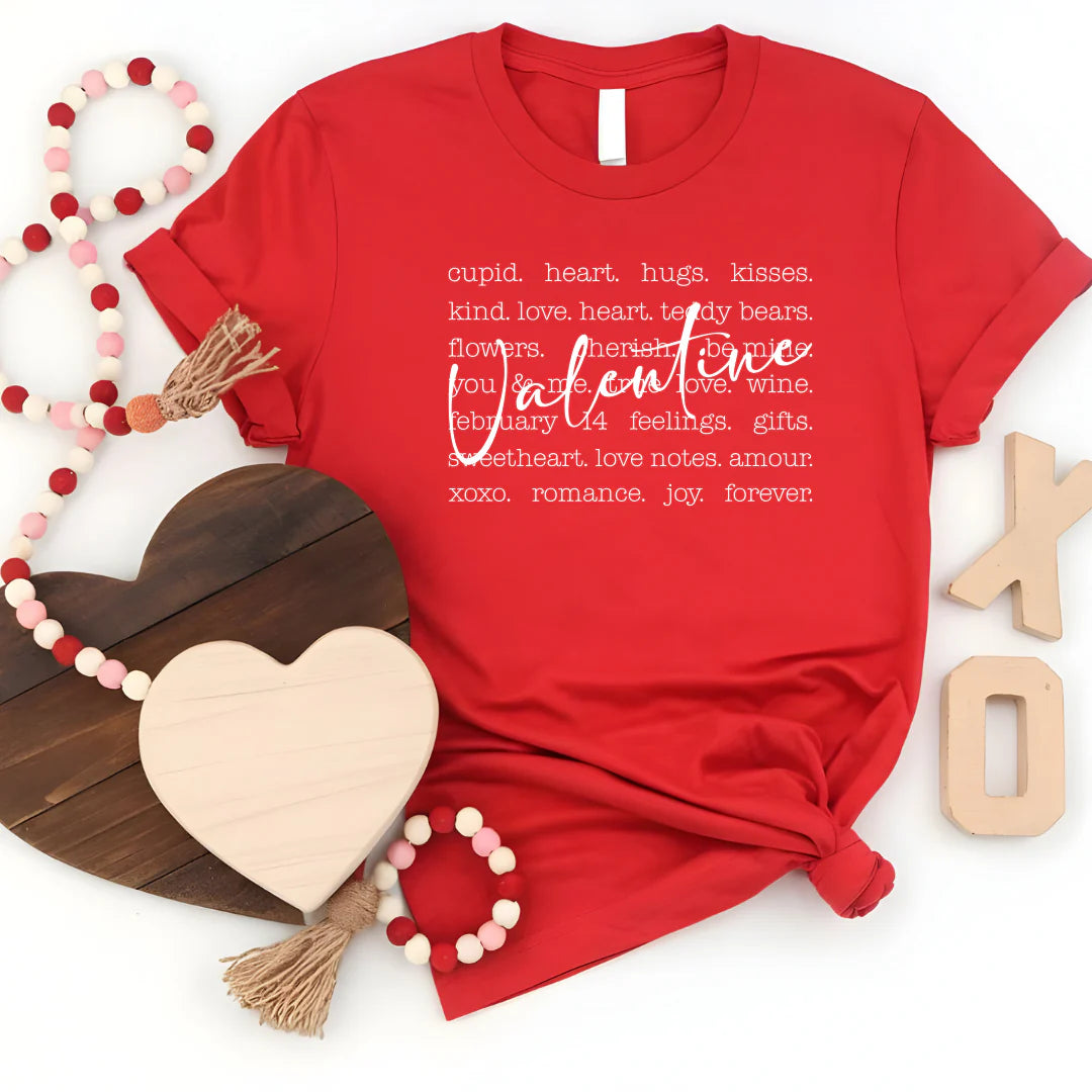 a red graphic tee with the word 'Valentine' printed along with various other words related to love and romance.