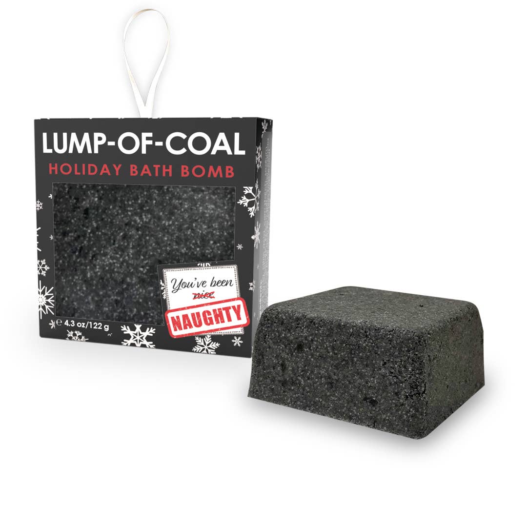 A black bath bomb named 'Lump-of-Coal'. The bath bomb is placed on a white surface, and it has a label that reads 'Lump of Coal - Holiday Bath Bomb.