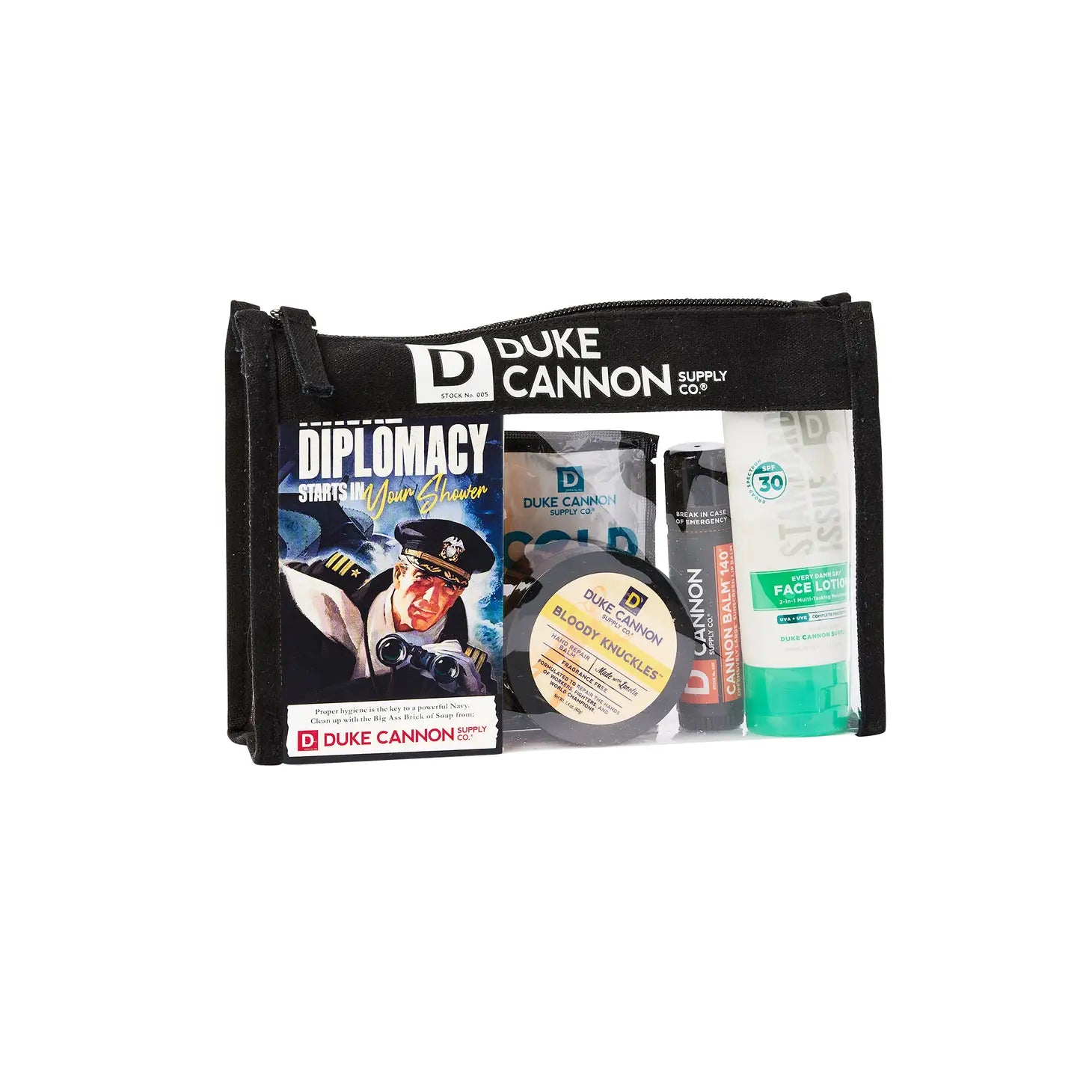 A gift set by Duke Cannon including various grooming products such as soap, a towel, lip protectant, hand repair balm, and face lotion, packed in a travel bag.