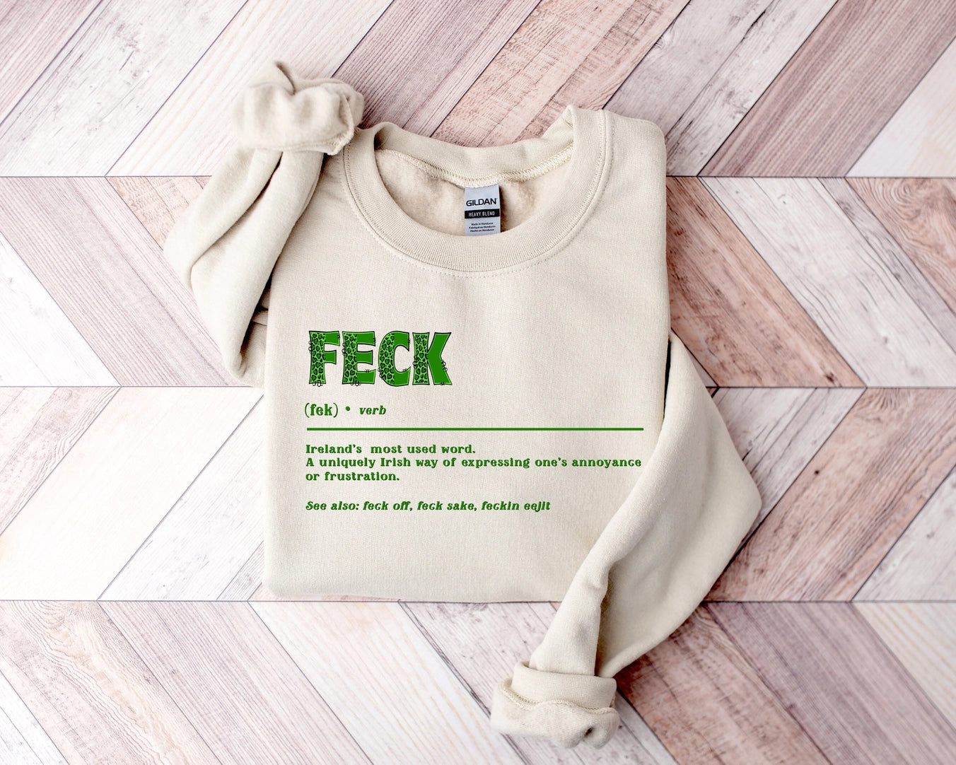 a beige sweatshirt with that reads 'FECK' (fek)- verb Ireland's most used word. A uniquely Irish way of expressing one's annoyance or frustration
See also: feck off, feck sake, feckin' eejit