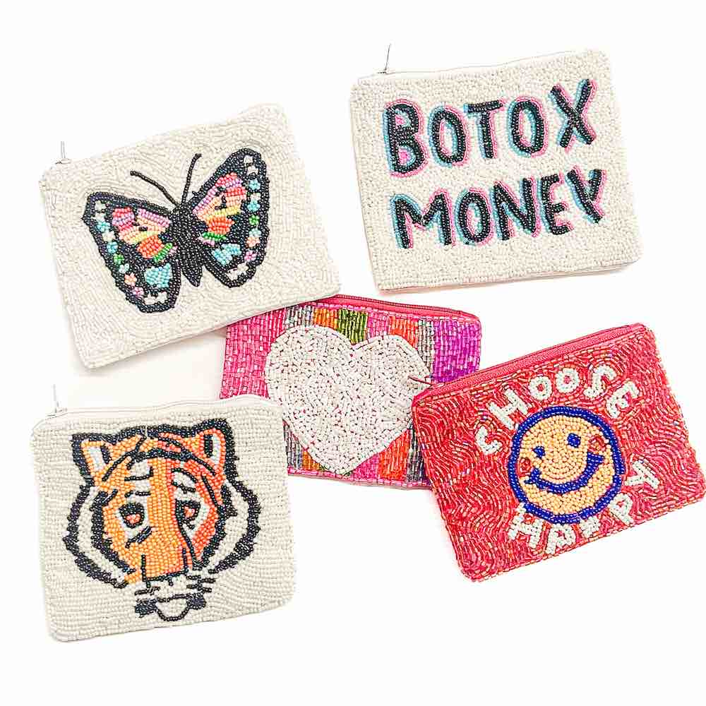 A red coin purse with decorative seed beadwork including a smiley face and the text 'CHOOSE HAPPY'.