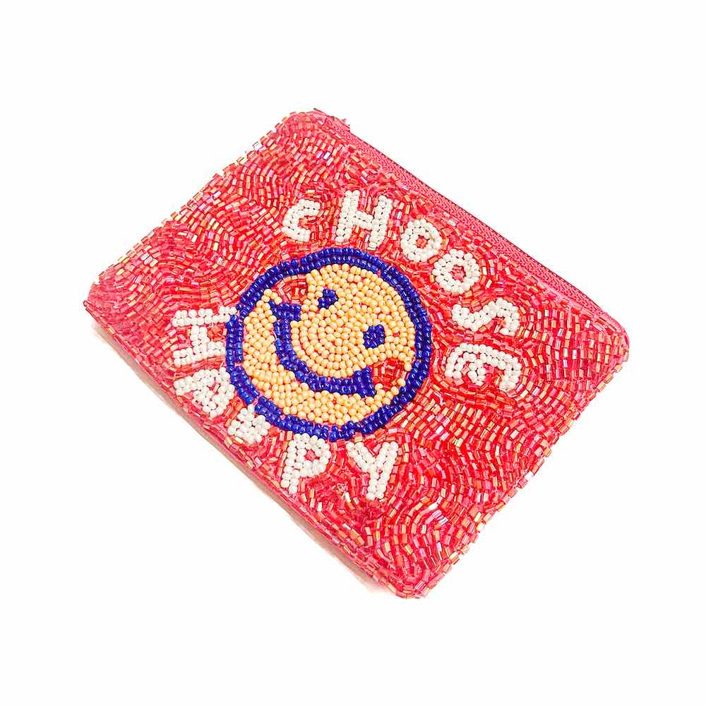 A red coin purse with decorative seed beadwork including a smiley face and the text 'CHOOSE HAPPY'.