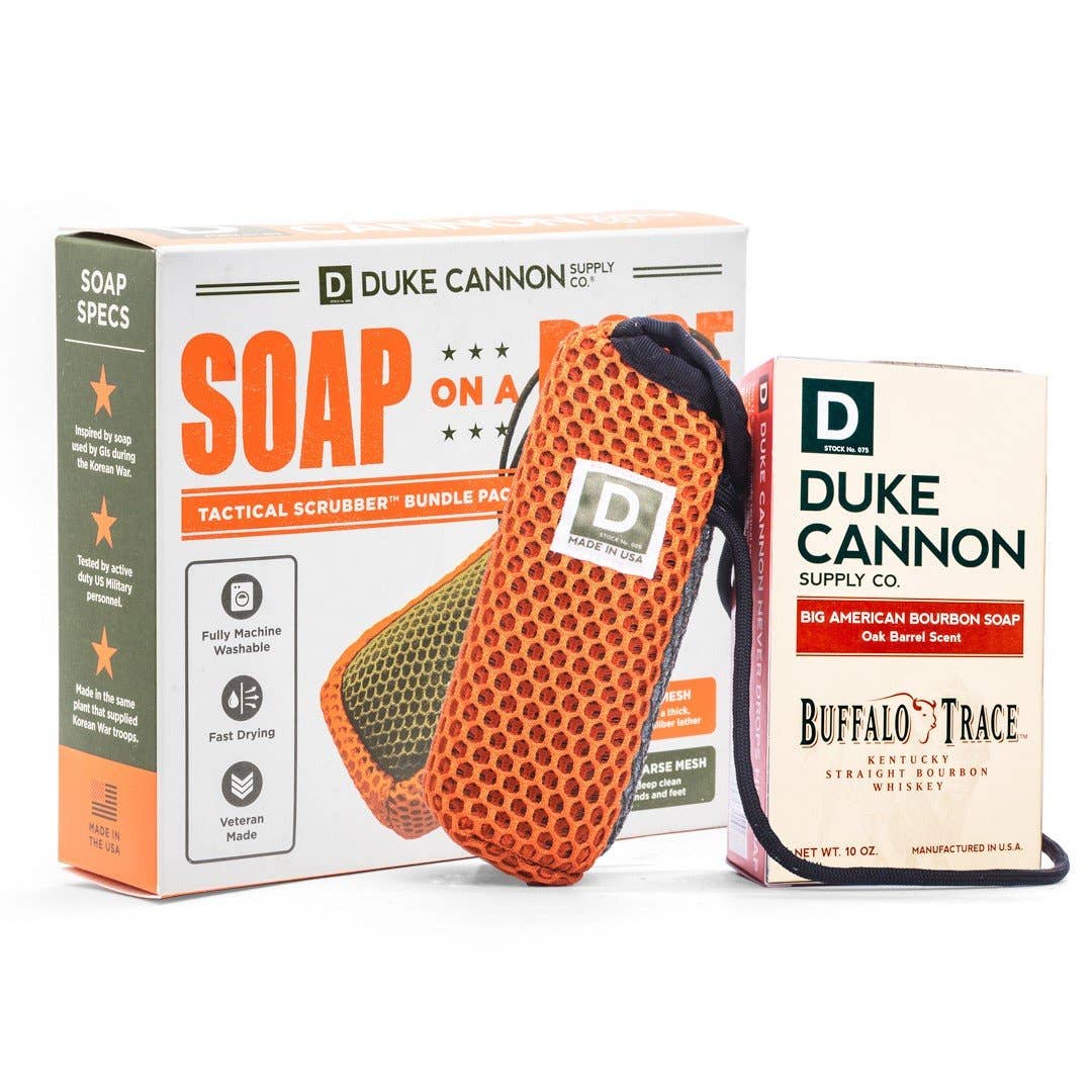 The product image features a bundle pack of Duke Cannon soap and a tactical scrubber. The scrubber is orange with a honeycomb pattern, and the soap packaging has the Duke Cannon Supply Co.
