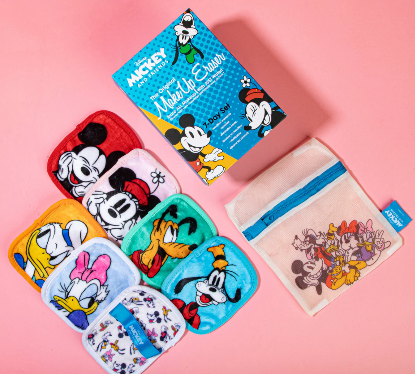 A set of seven Mickey and Friends makeup erasers displayed with a laundry bag and the product box.