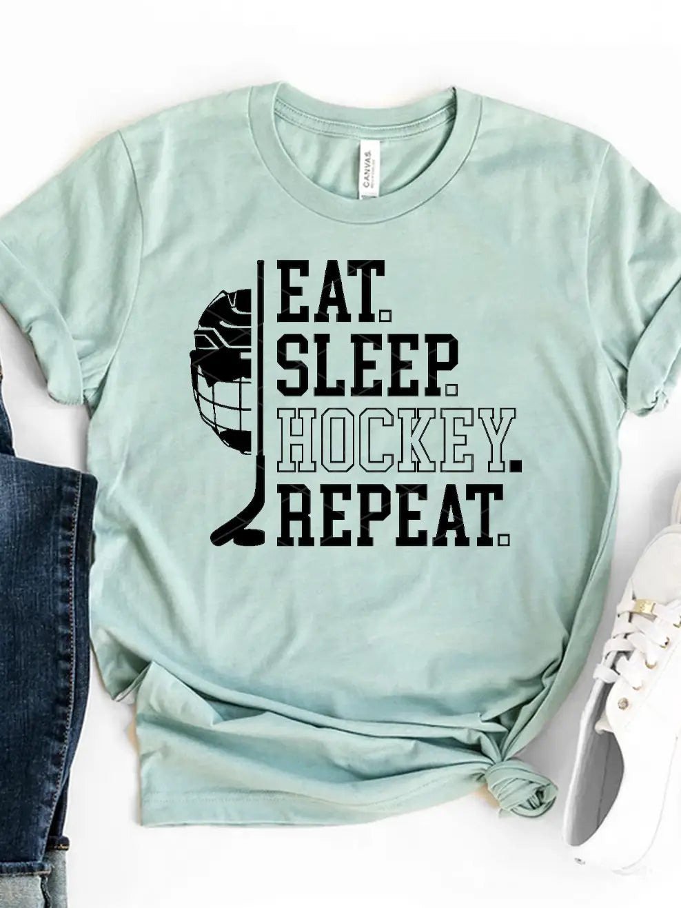 A graphic tee with the text 'EAT. SLEEP. HOCKEY. REPEAT.' printed on the front.