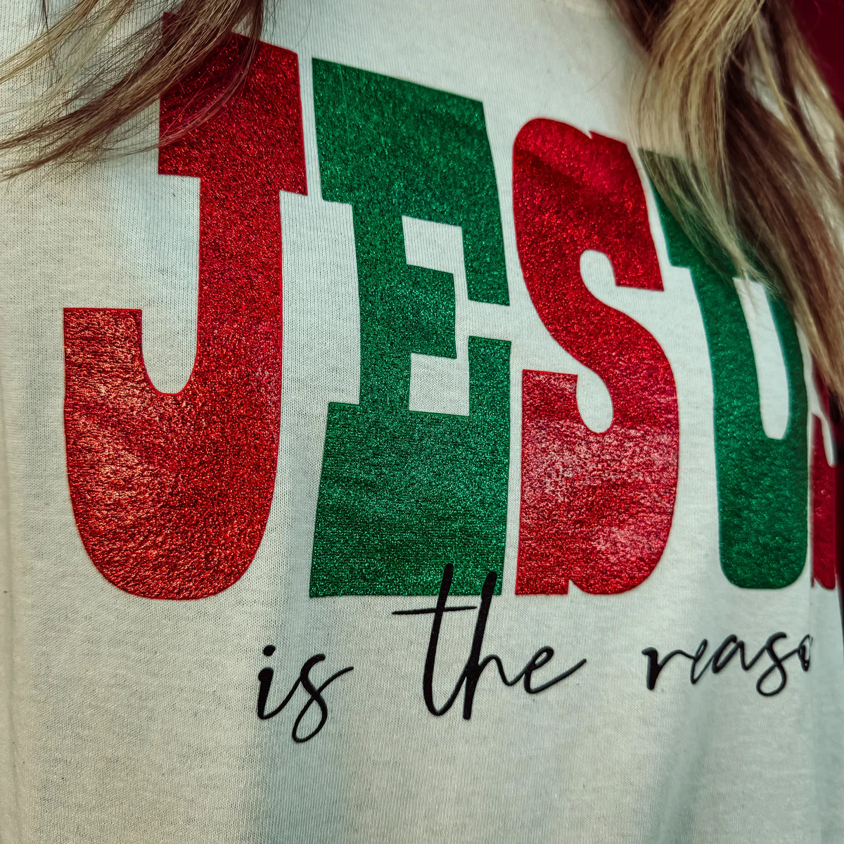 Woman wearing a Jesus is the reason long sleeve graphic tee.