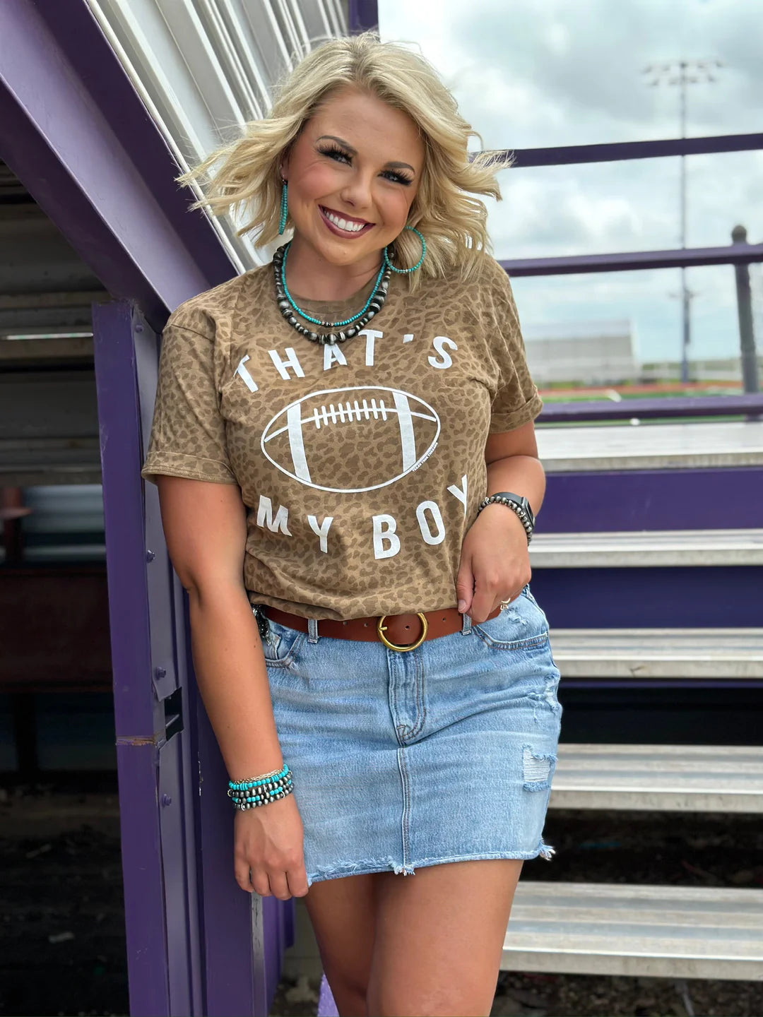 Woman wearing a leopard print t-shirt with 'That's My Boy' text and football graphic.
