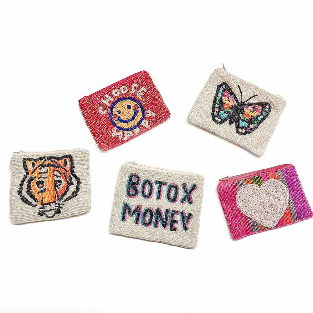 A red coin purse with decorative seed beadwork including a smiley face and the text 'CHOOSE HAPPY'.